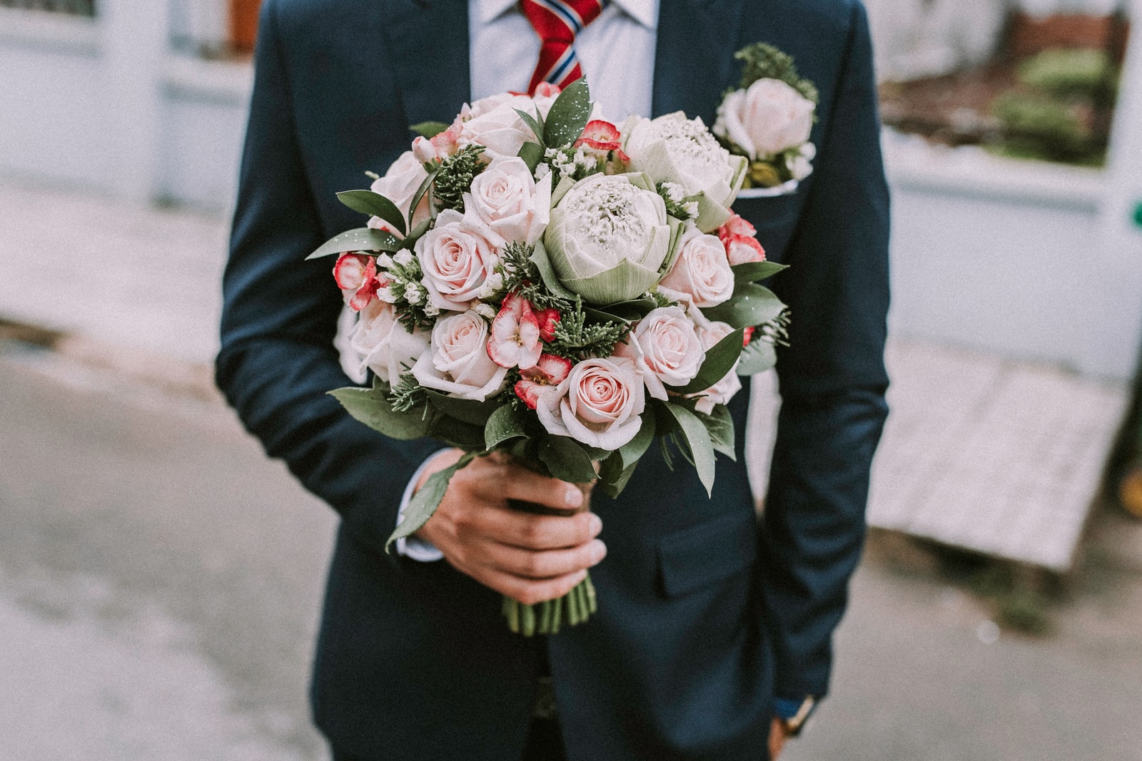 man holding a rose bouquet